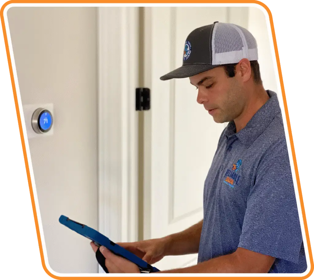 Reliable Ducts technician showing a homeowner repair details on a tablet during a heater repair visit