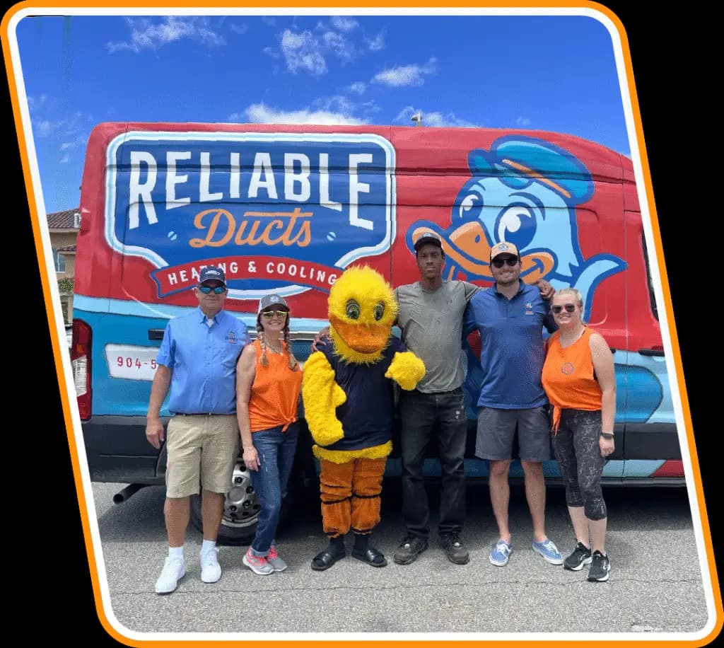 Reliable Ducts Heating & Cooling team and mascot with branded service van in St. Augustine, FL