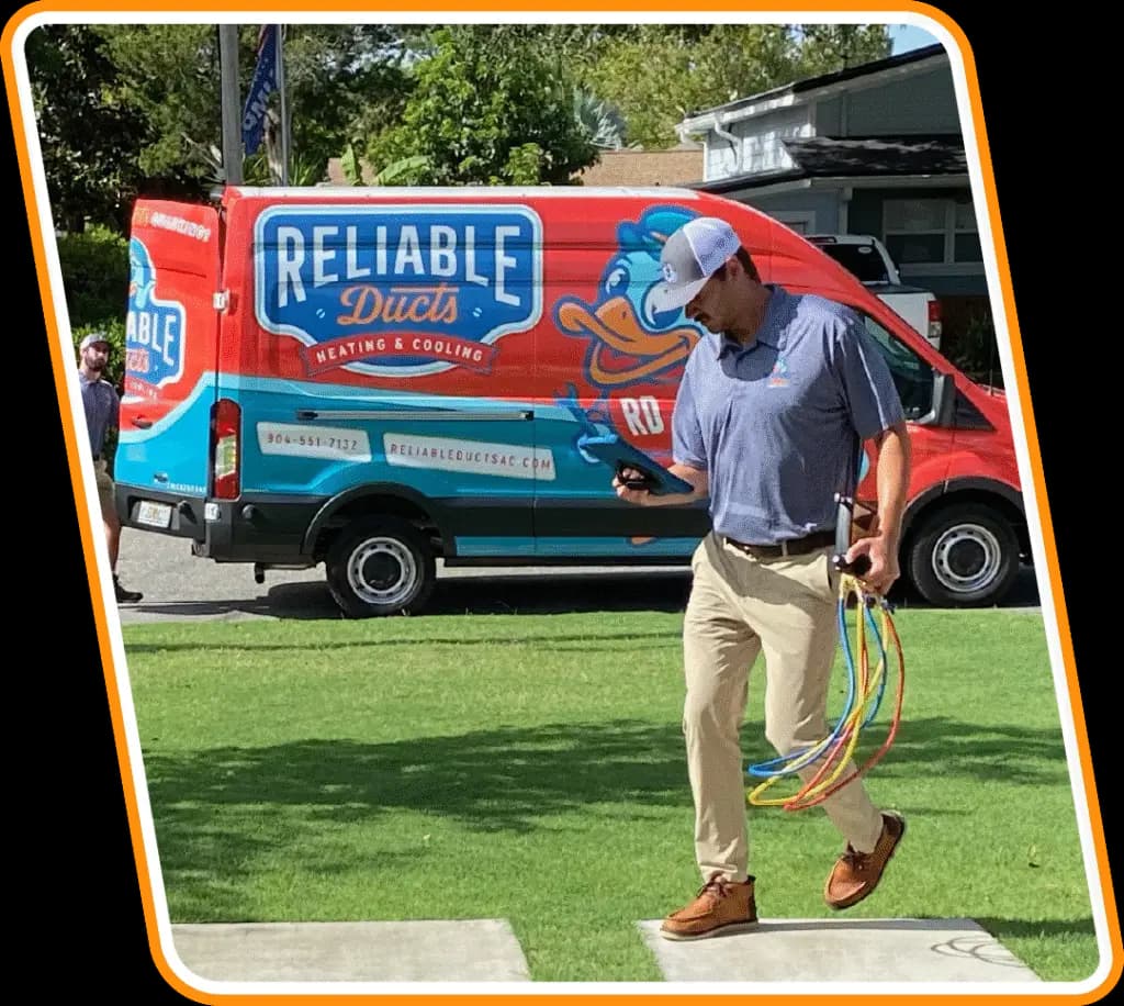Reliable Ducts HVAC technician with tools walking from branded service van to a Neptune Beach home for air conditioning service.
