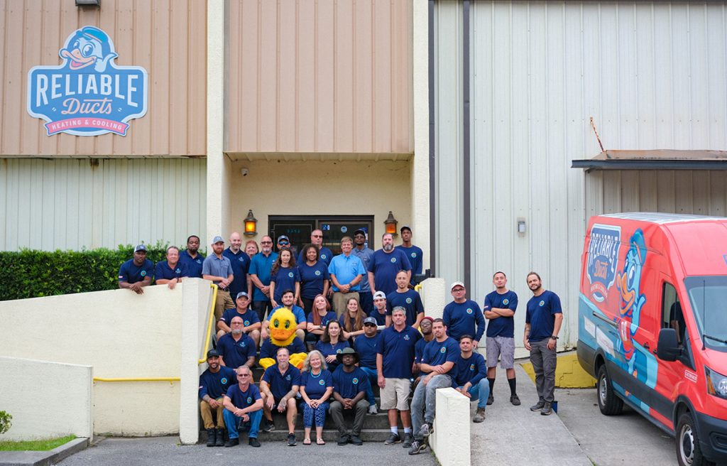 Group photo of workers outside of shop