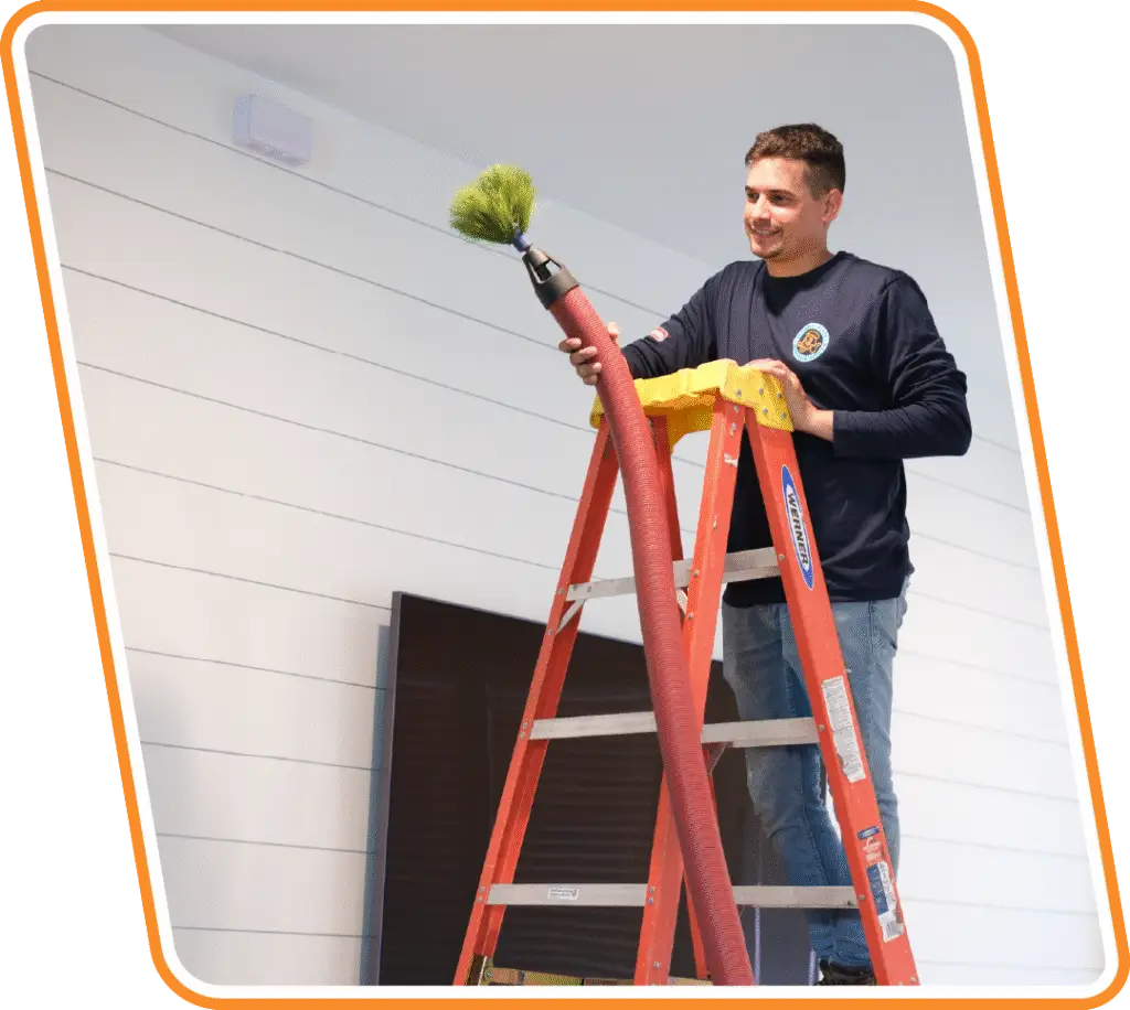 Reliable Ducts technician cleaning air ducts with professional equipment in Jacksonville, FL