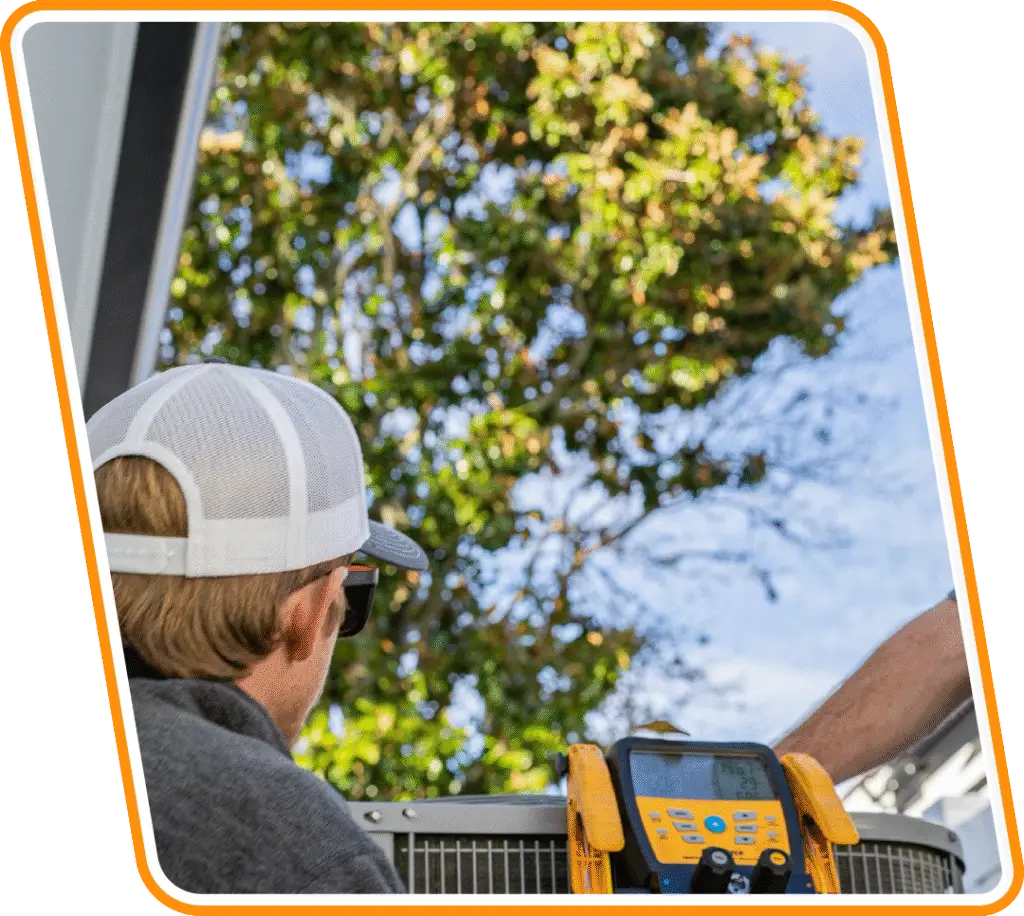 Technician performing AC maintenance and diagnostic testing on outdoor unit in Jacksonville Beach, FL.