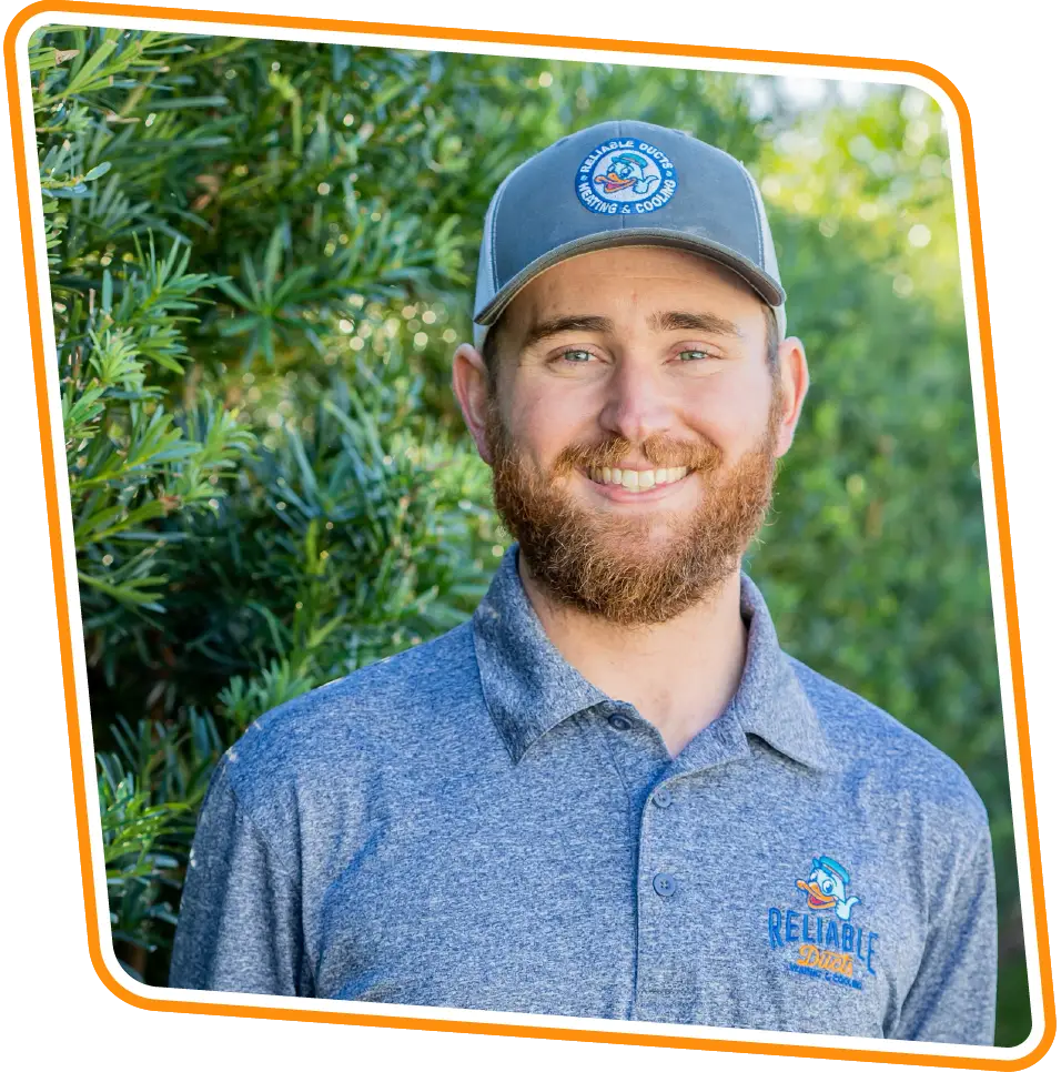 Reliable Ducts Heating & Cooling technician smiling outdoors in Orange Park, FL.