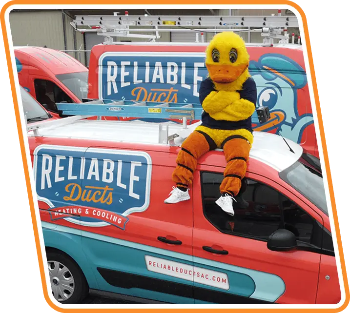 Reliable Ducts Heating & Cooling mascot sitting on top of branded service van, representing trusted AC repair and HVAC installation in Northeast Florida